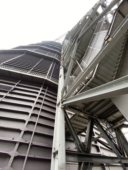 Close-up view of a large industrial structure with metal beams and staircases.